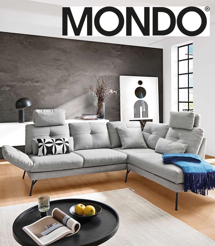 eine graue Couch in einem hellen Wohnzimmer .